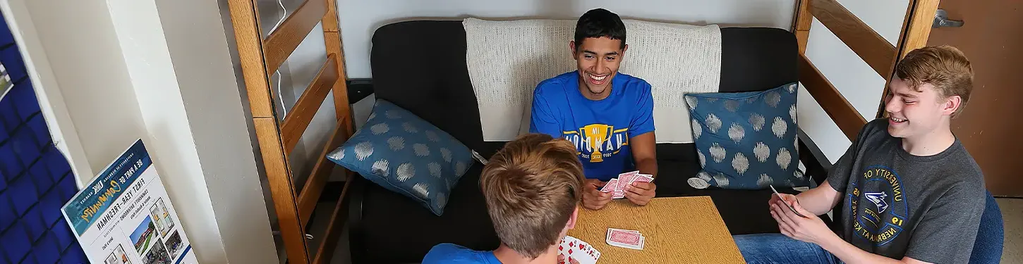 students playing cards in their dorm room