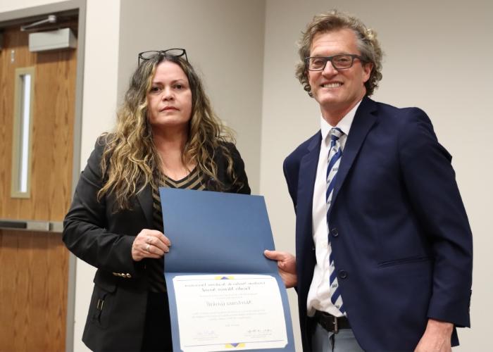 A man presenting a woman an award.