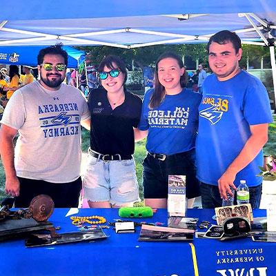 museum staff pose for a photo at the blue gold welcome event