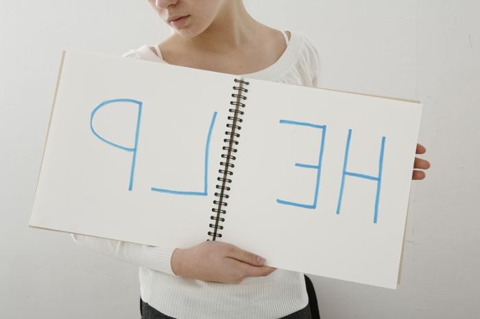 Person holding a sign that says Help